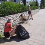 Trzy uczennice sprzątają teren przed hotelem